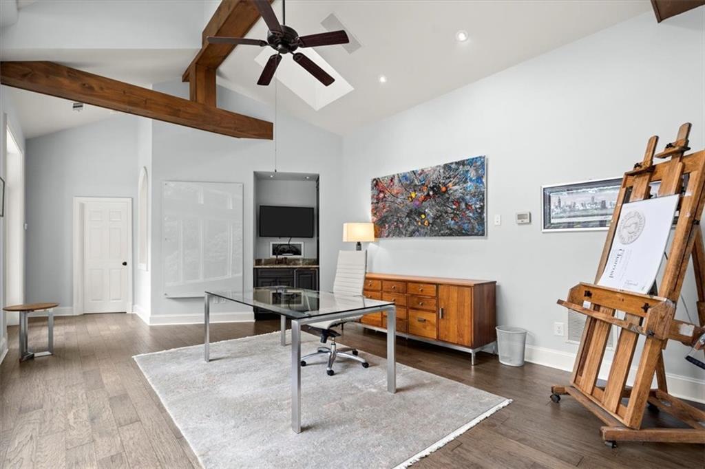Office space with dark wood-type flooring, beamed ceiling, high vaulted ceiling, and ceiling fan Office space with dark wood-type flooring, beamed ceiling, high vaulted ceiling, and ceiling fan