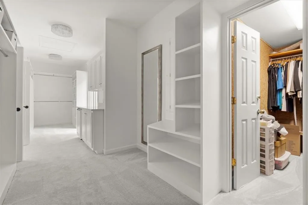 Spacious closet featuring light colored carpet Spacious closet featuring light colored carpet