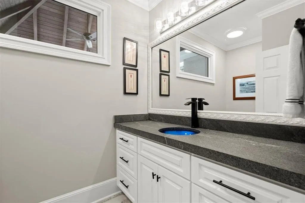 Bathroom with ornamental molding and oversized vanity Bathroom with ornamental molding and oversized vanity