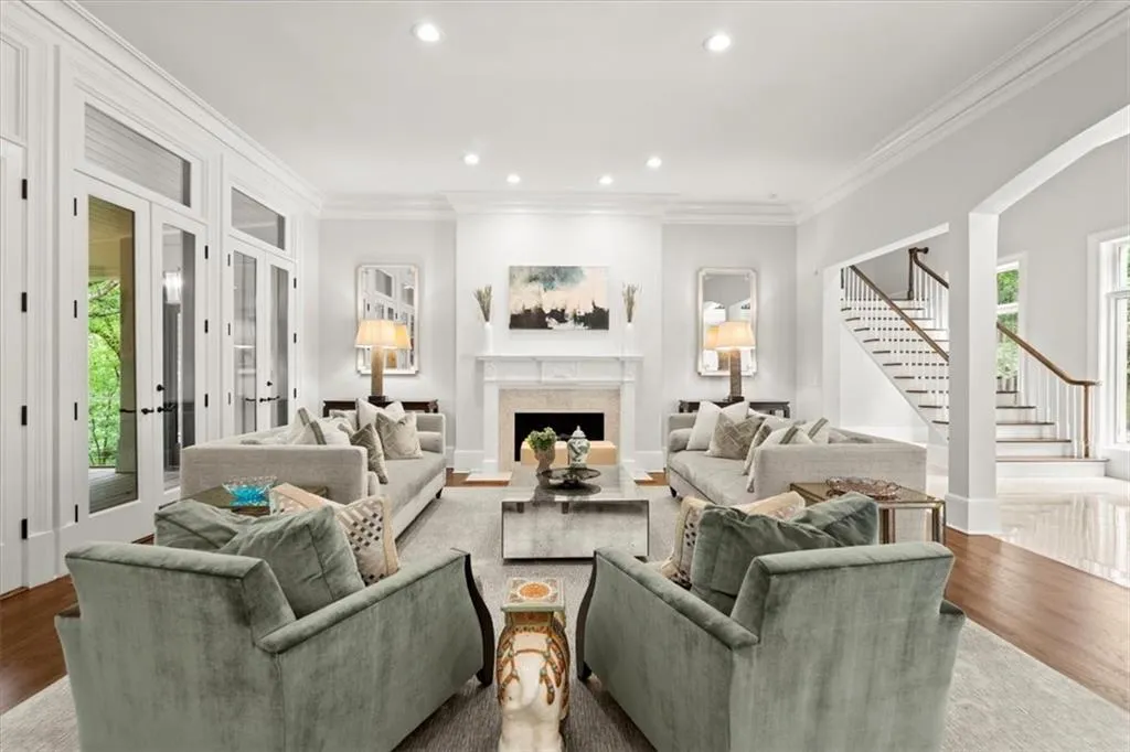 Living room featuring ornamental molding and light hardwood / wood-style floors Living room featuring ornamental molding and light hardwood / wood-style floors