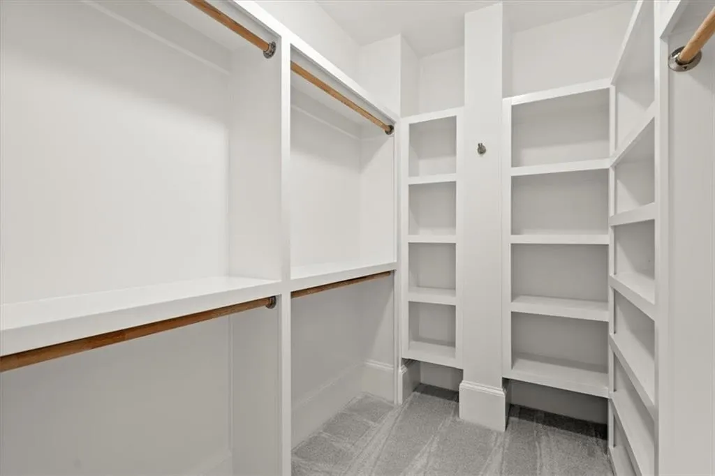 Walk in closet with carpet floors Walk in closet with carpet floors