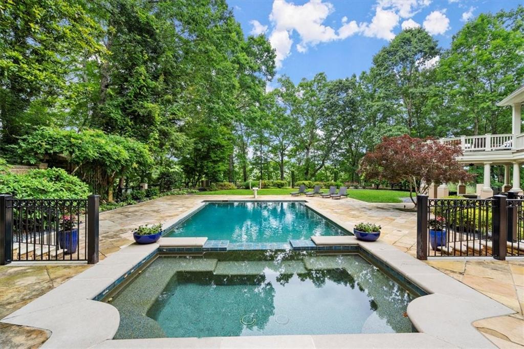 View of swimming pool with an in ground hot tub and a patio area View of swimming pool with an in ground hot tub and a patio area