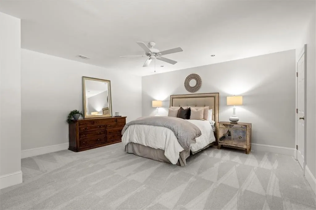 Carpeted bedroom featuring ceiling fan Carpeted bedroom featuring ceiling fan