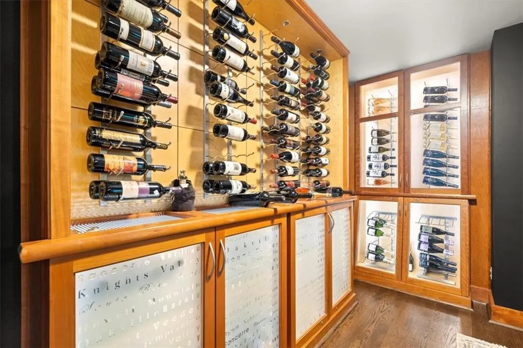 Wine room with dark hardwood / wood-style floors and bar area Wine room with dark hardwood / wood-style floors and bar area