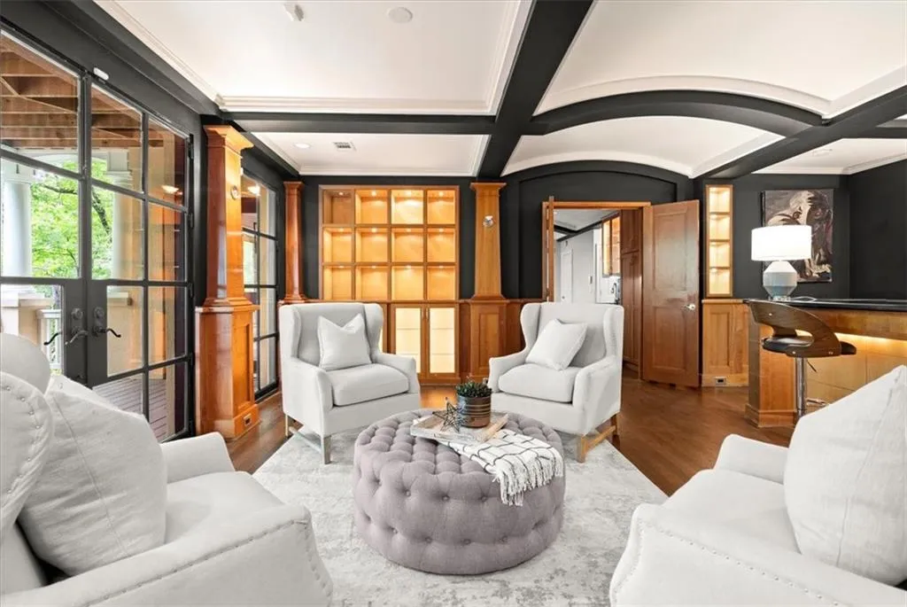 Living room with coffered ceiling, french doors, beam ceiling, decorative columns, and dark hardwood / wood-style floors Living room with coffered ceiling, french doors, beam ceiling, decorative columns, and dark hardwood / wood-style floors