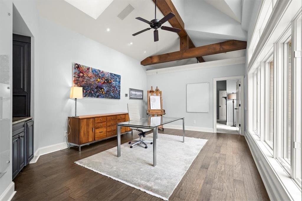 Office area featuring beam ceiling, high vaulted ceiling, dark hardwood / wood-style floors, and ceiling fan Office area featuring beam ceiling, high vaulted ceiling, dark hardwood / wood-style floors, and ceiling fan
