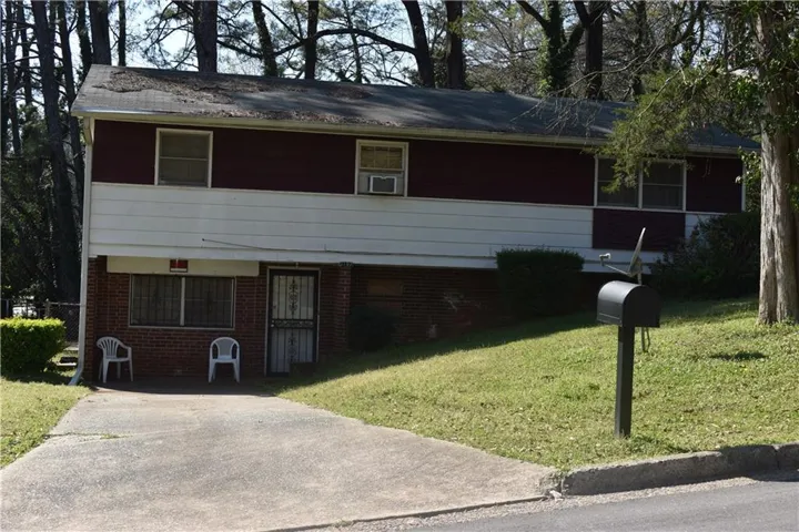 View of front of home featuring a front yard and brick siding