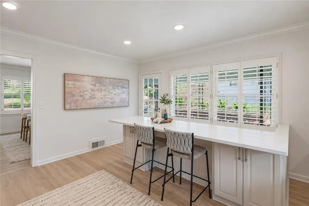 Built-in cabinetry with a white countertop, wood-finish flooring, recessed lighting, and white plantation shutters