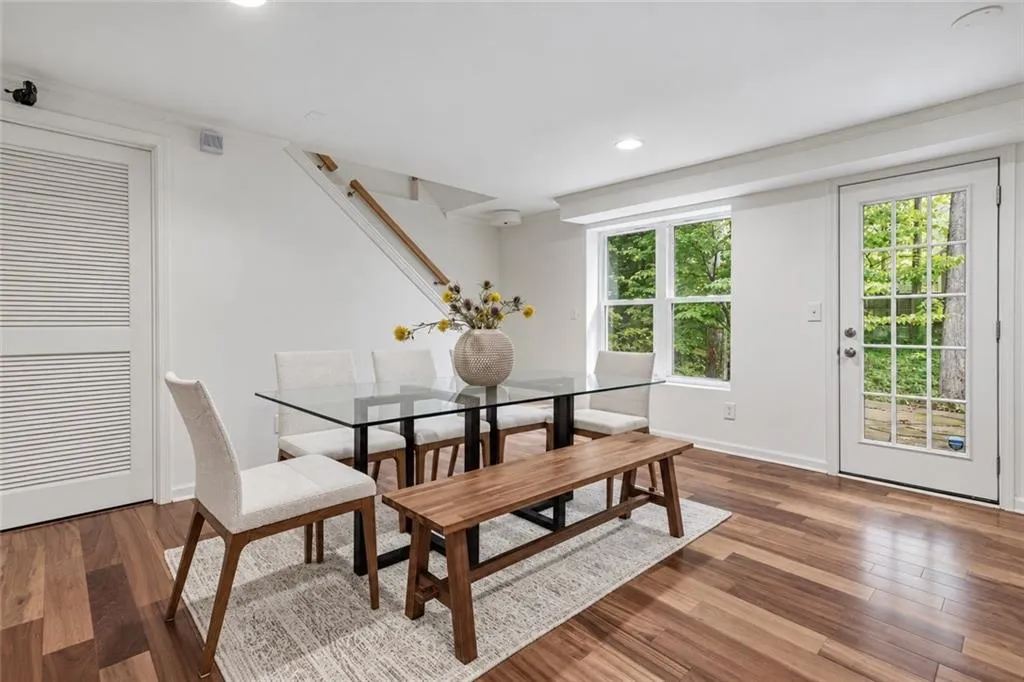 Wood-finish flooring, recessed lighting, double-hung windows, and a glass-paneled exterior door