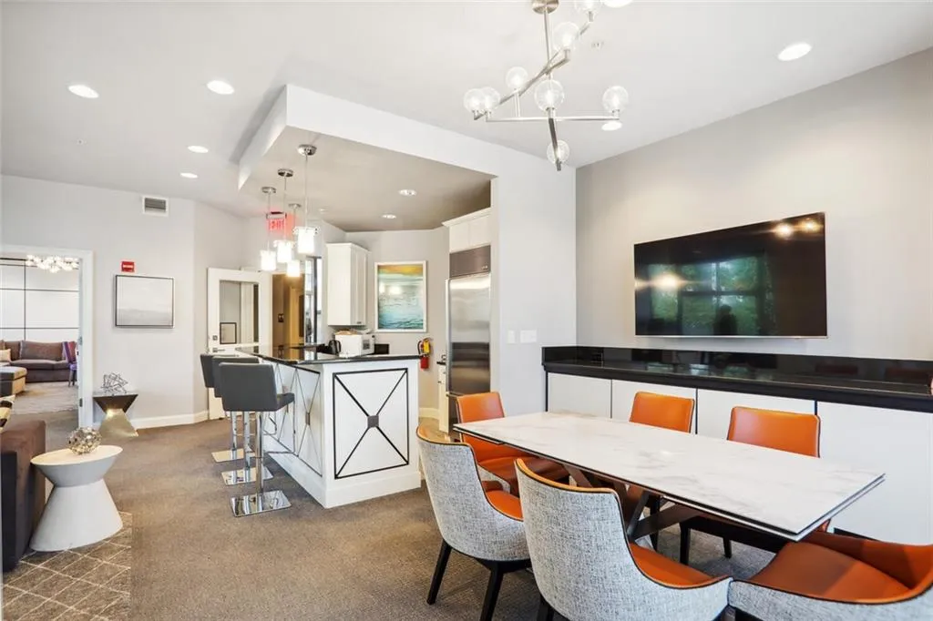 Dining room with baseboards, visible vents, dark colored carpet, a notable chandelier, and recessed lighting