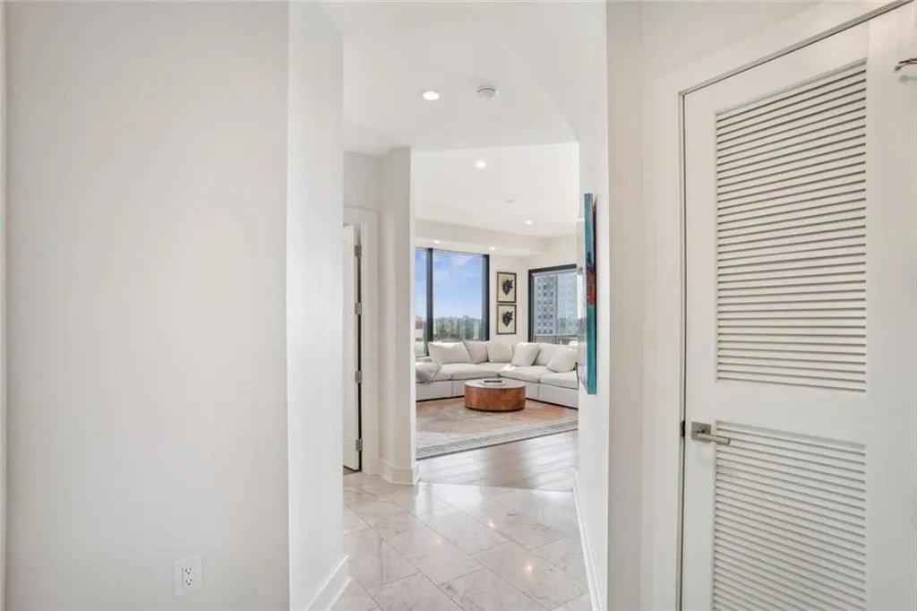 Hall featuring marble finish floor and recessed lighting