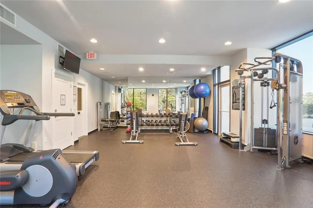 Exercise room with visible vents and recessed lighting