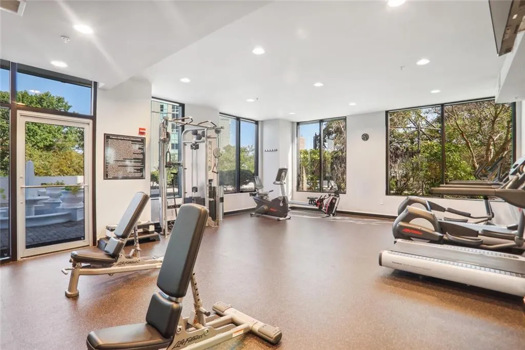 Gym featuring floor to ceiling windows, visible vents, and recessed lighting