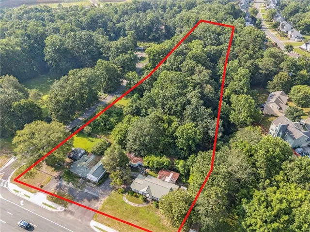 Expansive wooded parcel featuring a mix of mature deciduous trees and open ground