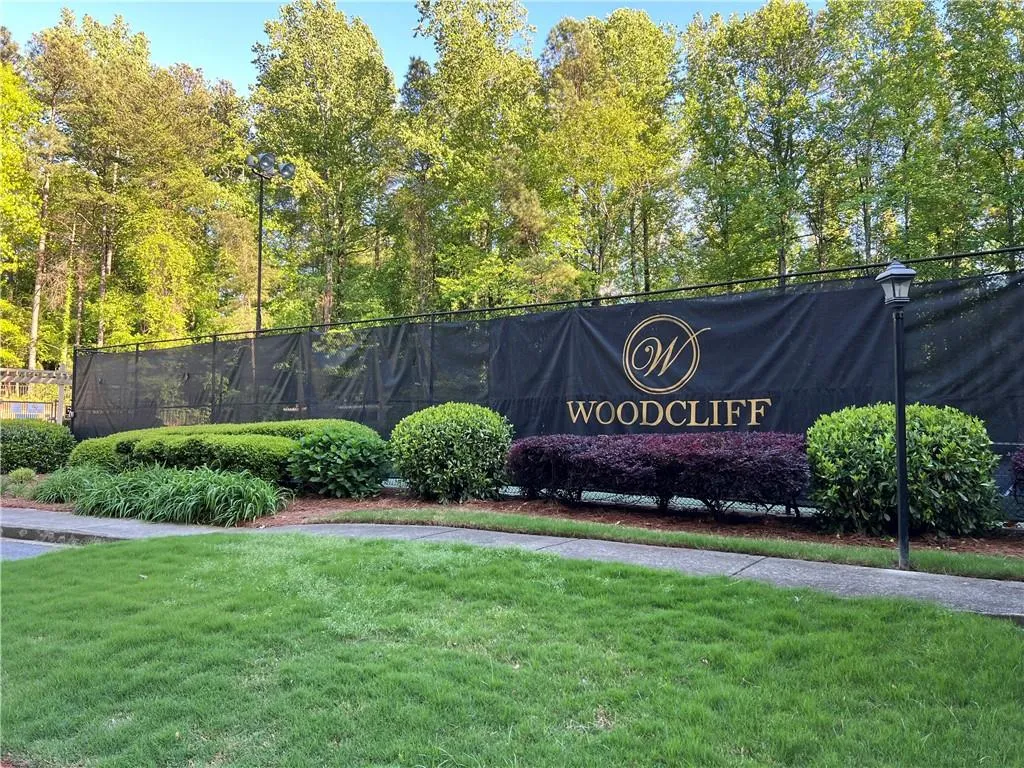 Community / neighborhood sign featuring a yard