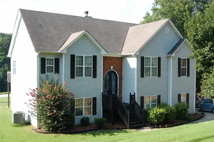 Light gray siding exterior with dark shutters