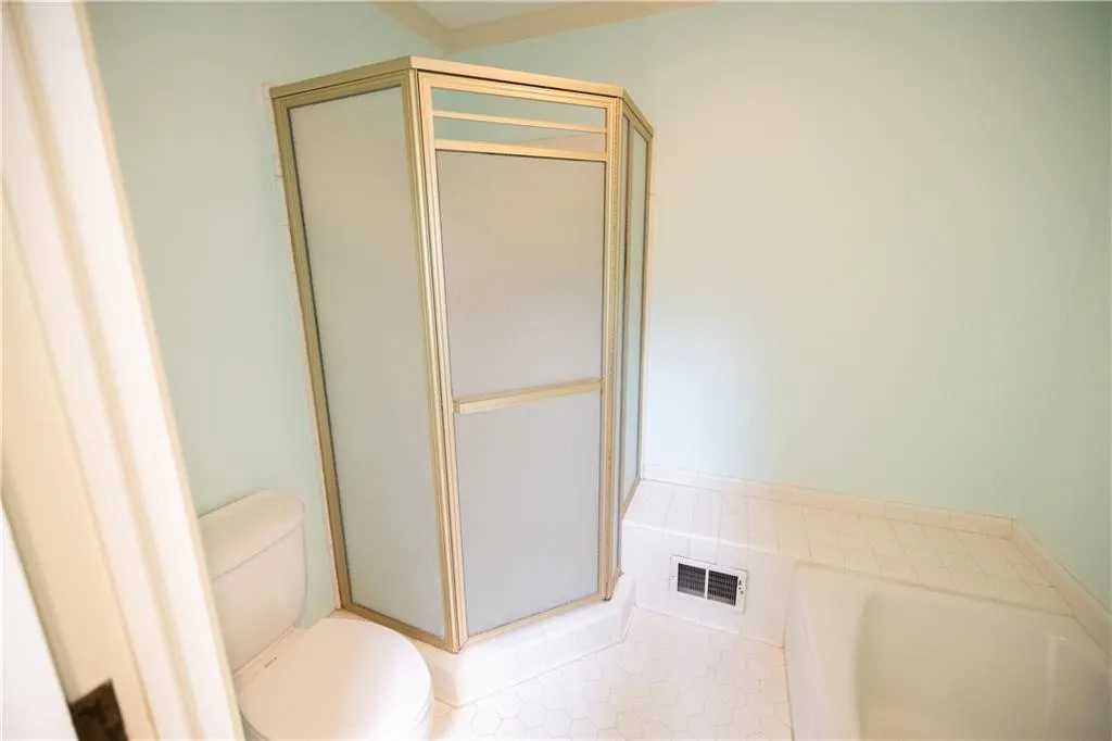 Bathroom with a bath, tile patterned floors, and a shower stall
