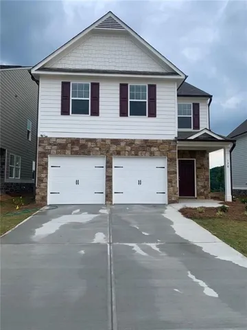 Two-story residence featuring a stone facade and white siding