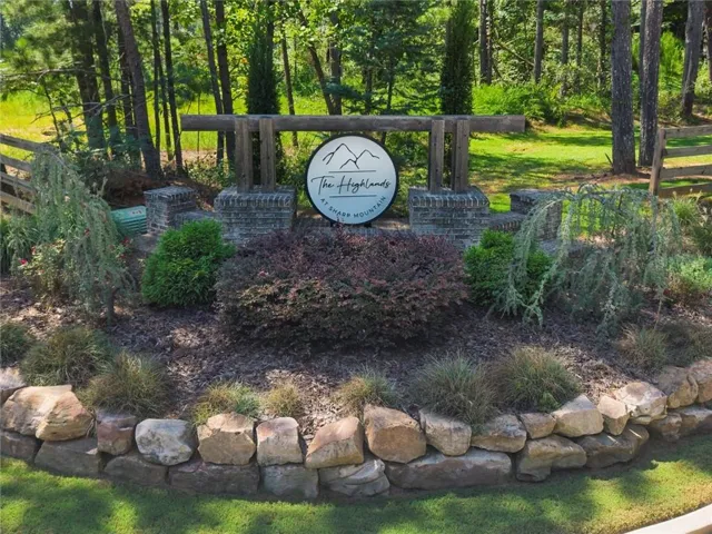 Stone retaining wall with a landscaped garden bed featuring diverse plantings