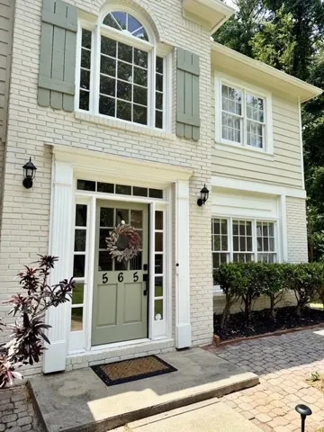 Brick exterior with painted finish and decorative shutters