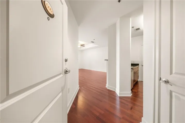 Foyer entry with wood-finish flooring, crisp white walls, and a recessed ceiling