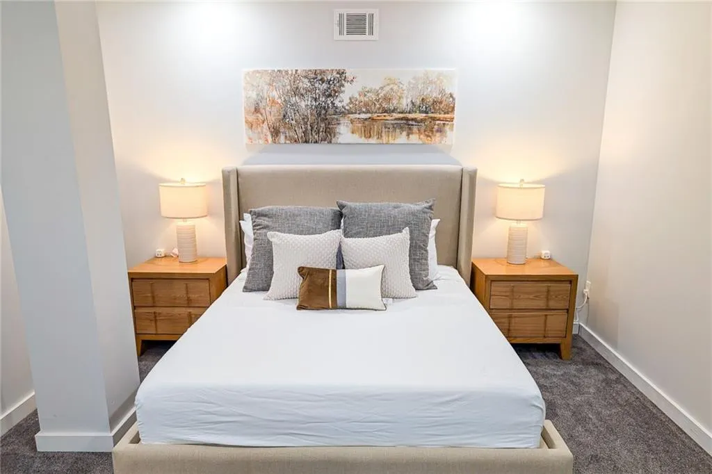 Bedroom featuring dark colored carpet