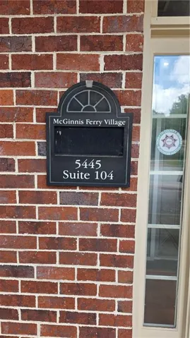 Brick exterior with a prominent suite number plaque