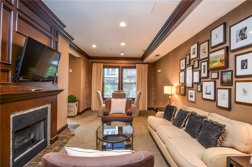 Living room featuring ornamental molding and a tiled fireplace