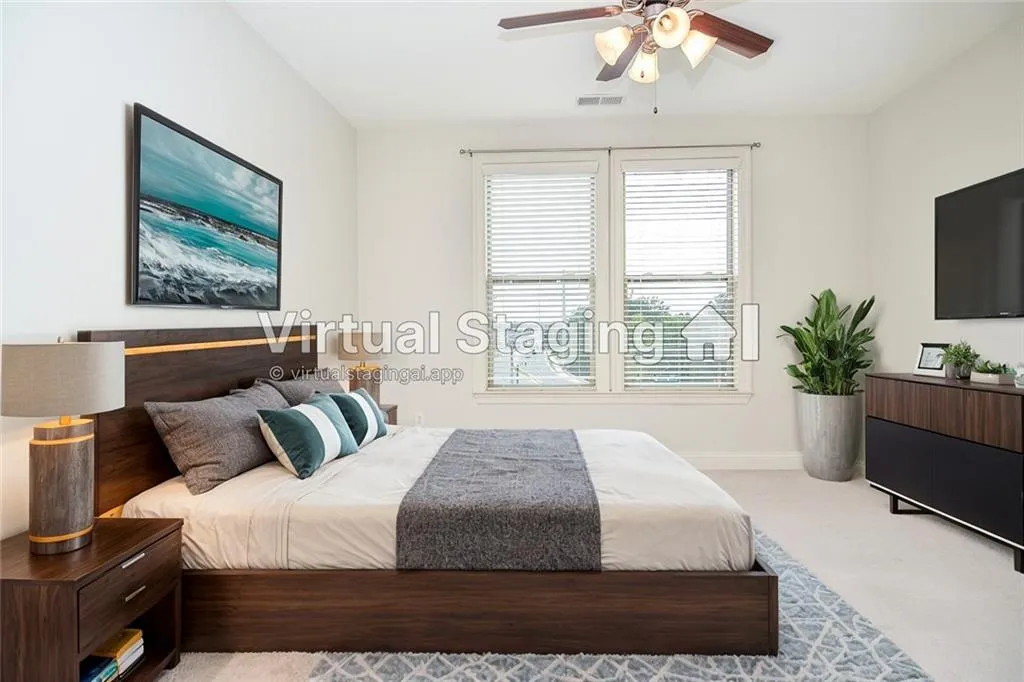 Bedroom featuring ceiling fan and light colored carpet
