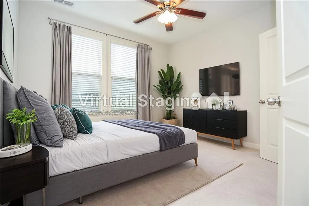 Carpeted bedroom with ceiling fan