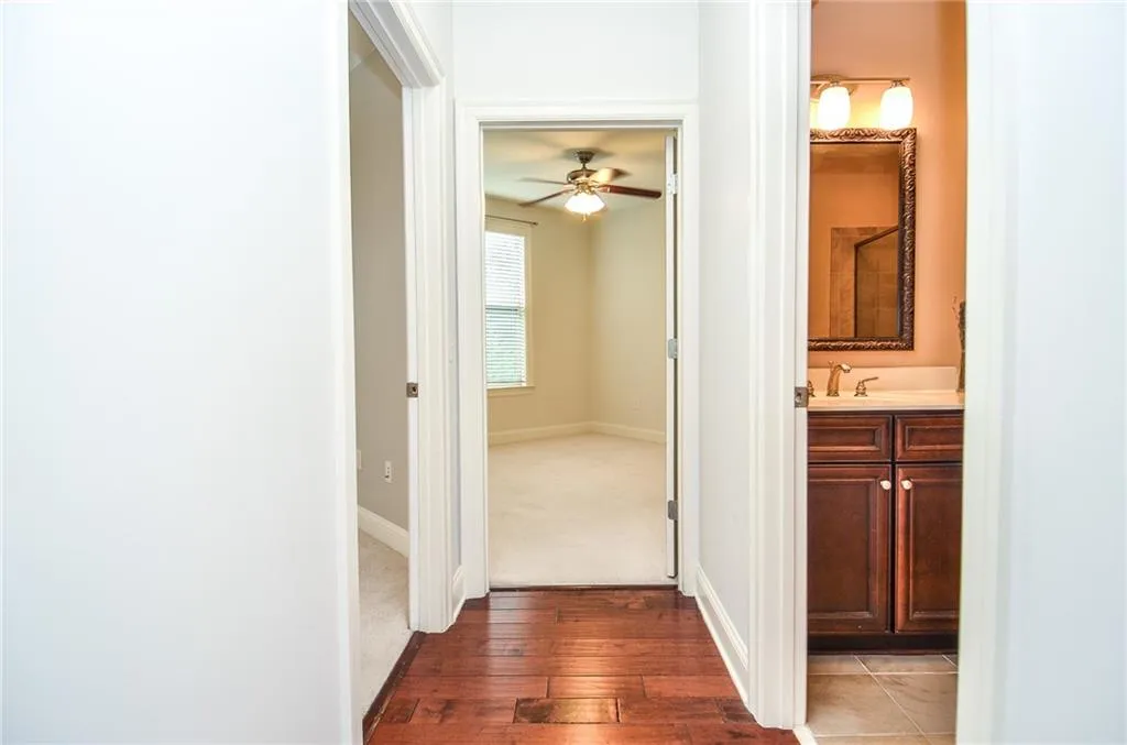 Corridor featuring dark hardwood / wood-style flooring and sink