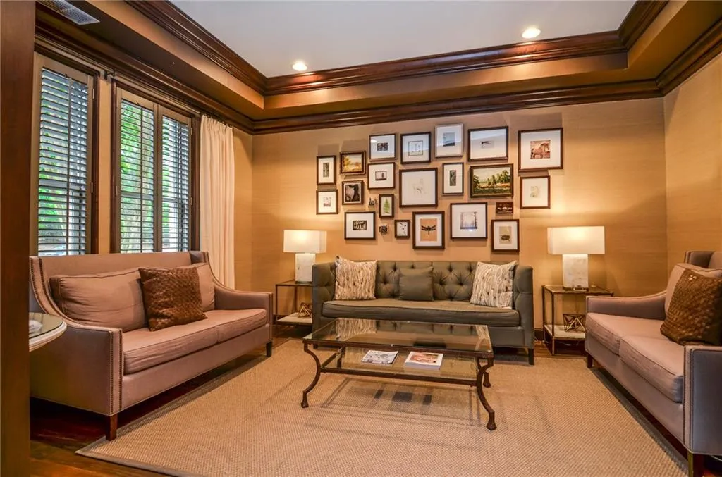 Living area with ornamental molding and hardwood / wood-style floors