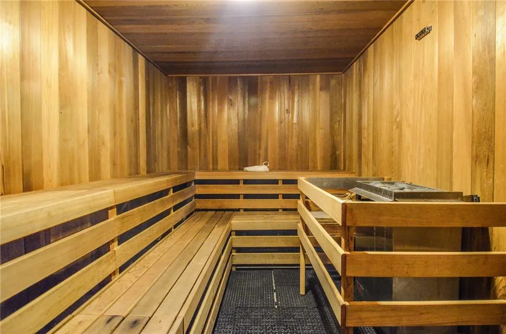 View of sauna with wood ceiling, wood walls, and tile patterned flooring