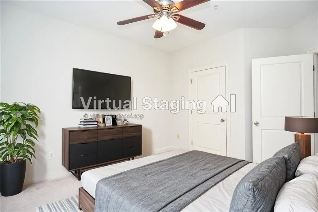 Carpeted bedroom with ceiling fan