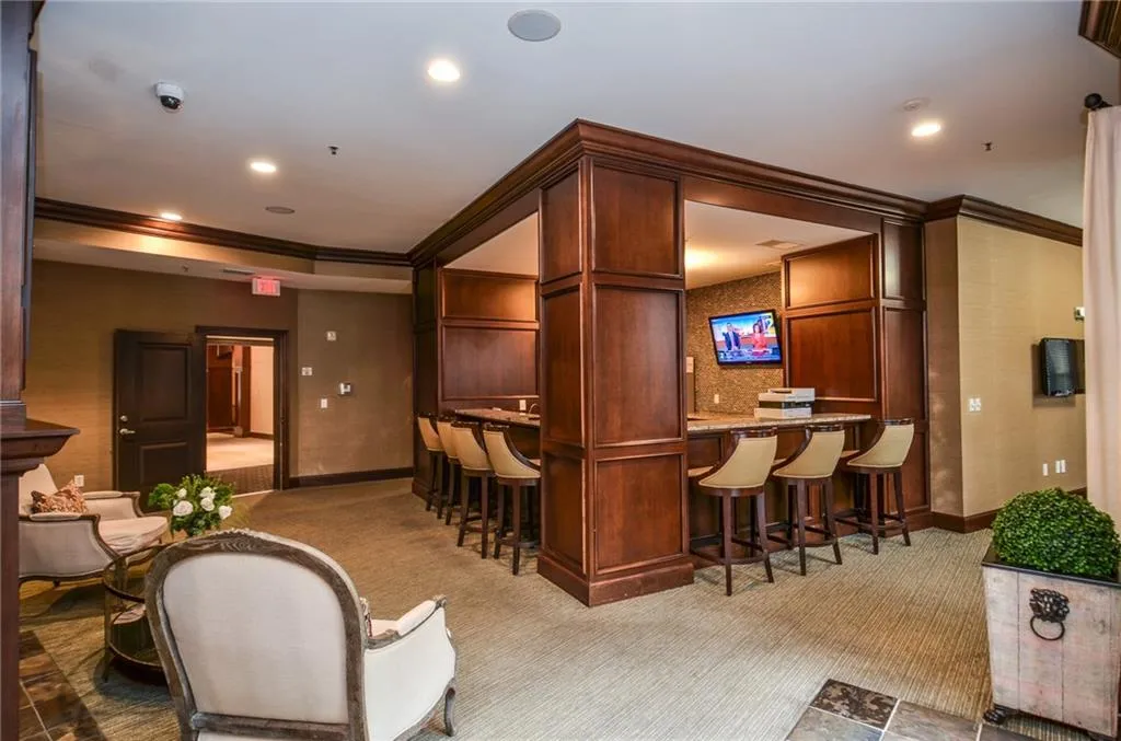 Bar with light carpet and crown molding