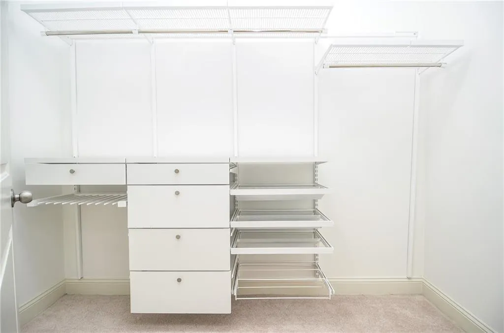 Walk in closet featuring light carpet