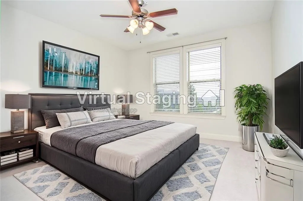 Carpeted bedroom featuring ceiling fan