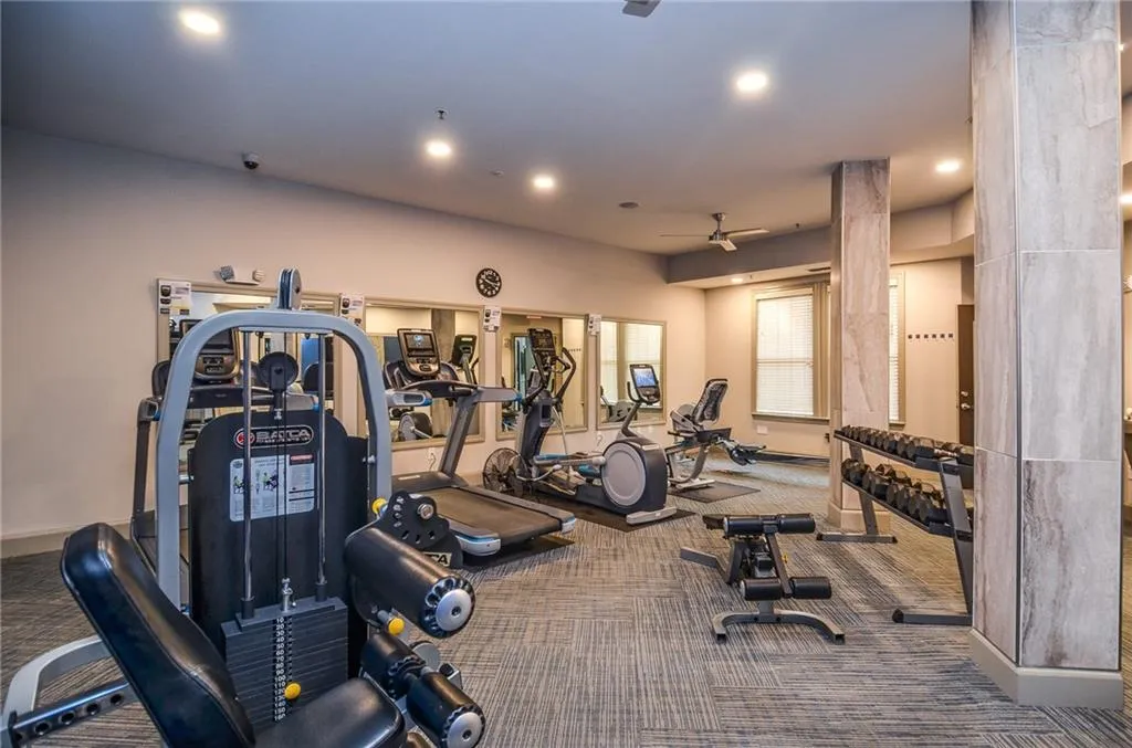 Exercise room with carpet and decorative columns
