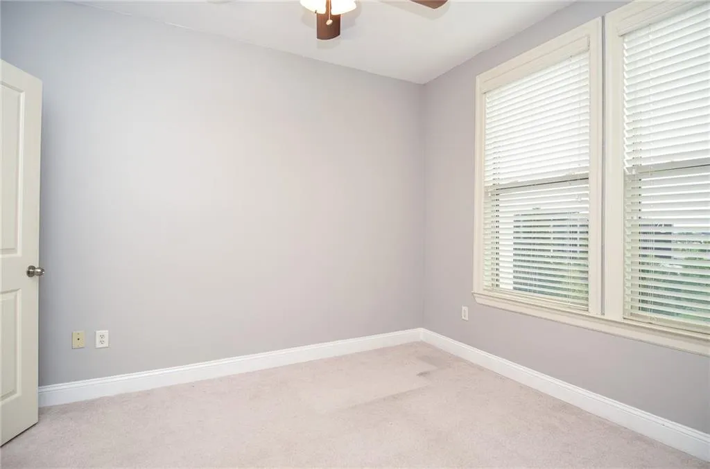 Unfurnished room with light carpet and ceiling fan