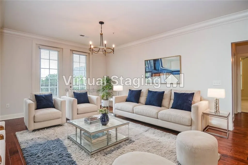 Living room with ornamental molding, a chandelier, and hardwood / wood-style floors