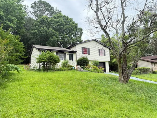 Split level home with a front lawn