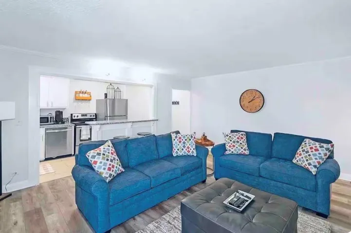 Bright living area featuring wood-finish flooring and a white color palette