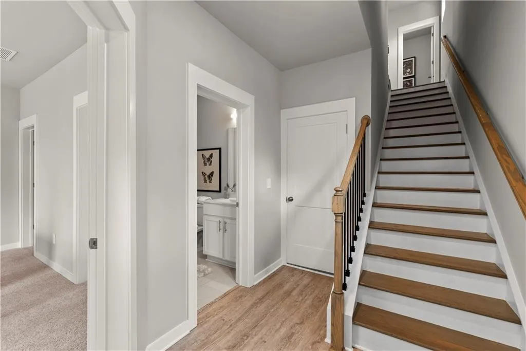 Staircase featuring wood finished floors and baseboards
