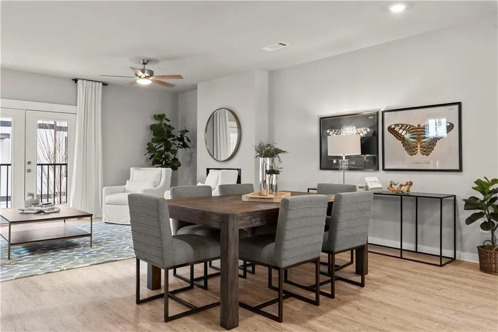Dining area with light wood-type flooring, french doors, and ceiling fan