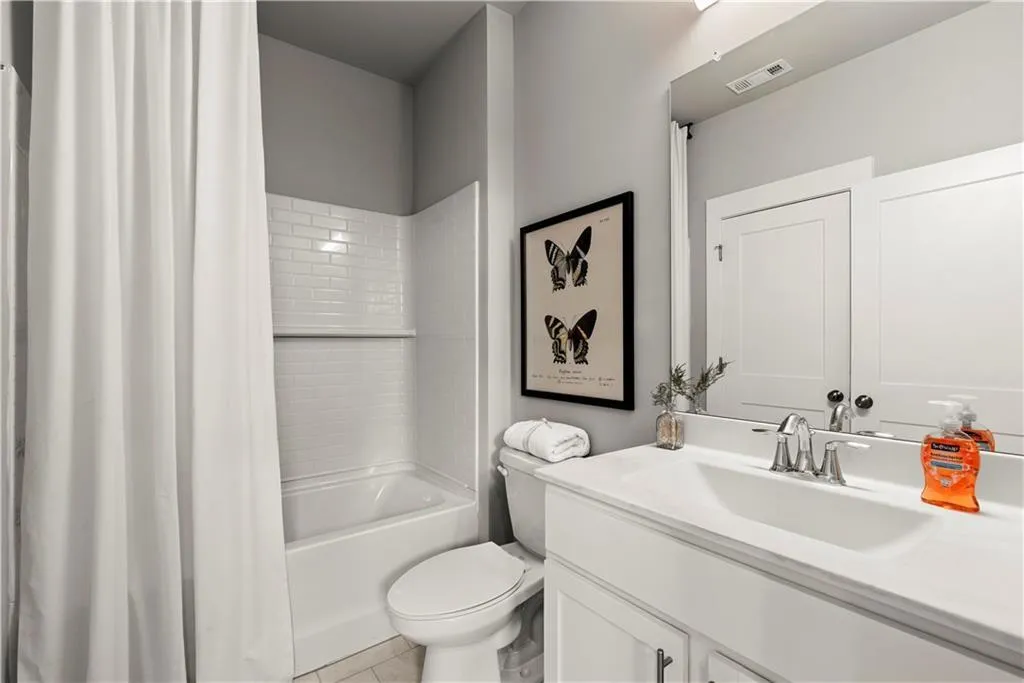 Full bathroom featuring vanity, shower / tub combo, and light tile patterned floors