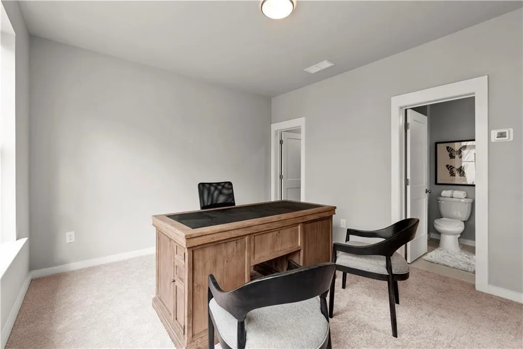 Office featuring baseboards and light colored carpet