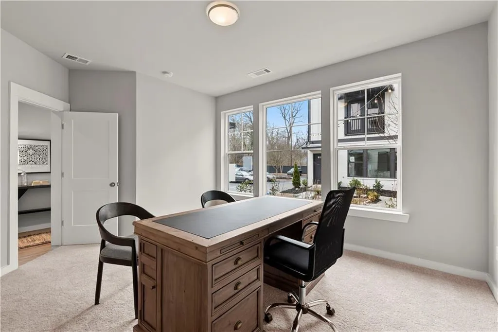 Office featuring light carpet and baseboards