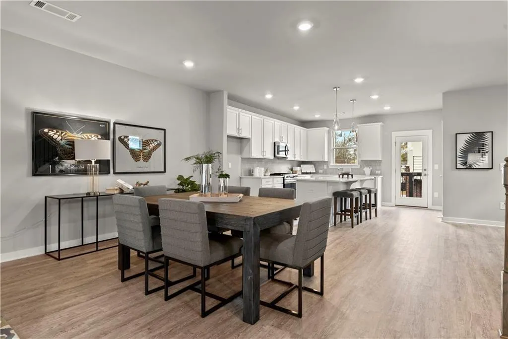Dining area featuring recessed lighting and light wood-style flooring