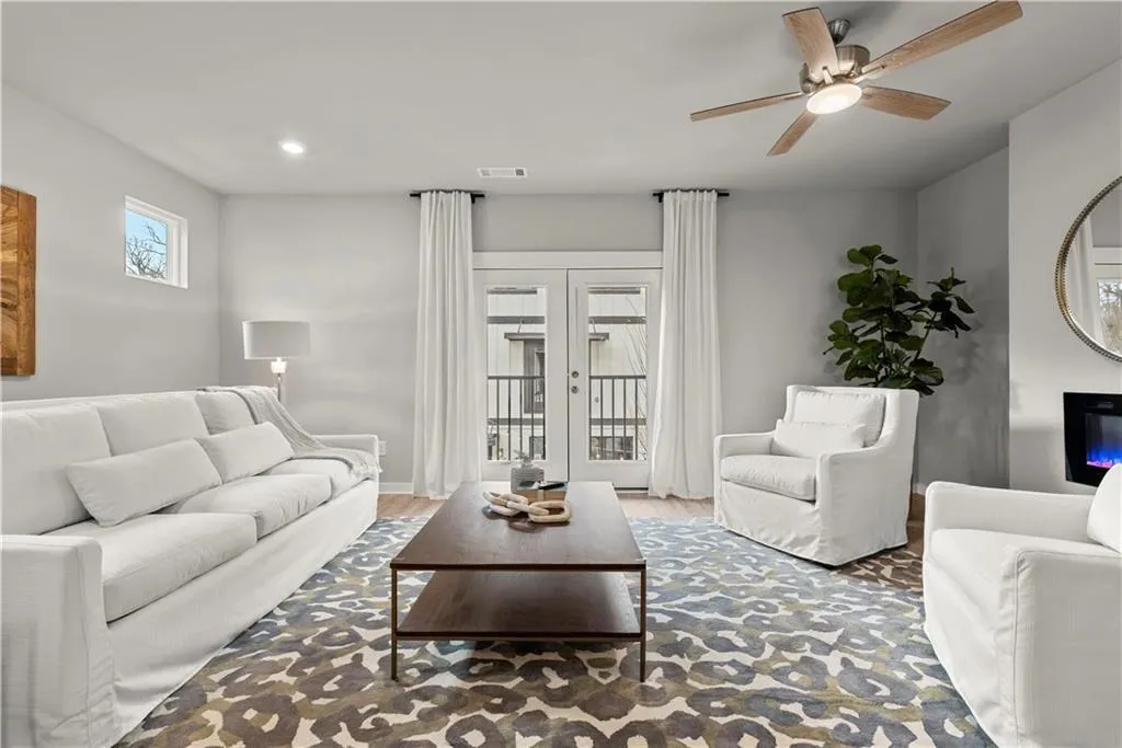 Living room featuring wood finished floors, a ceiling fan, and recessed lighting