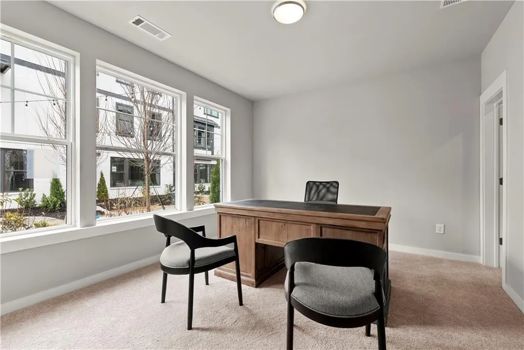 Home office featuring light colored carpet